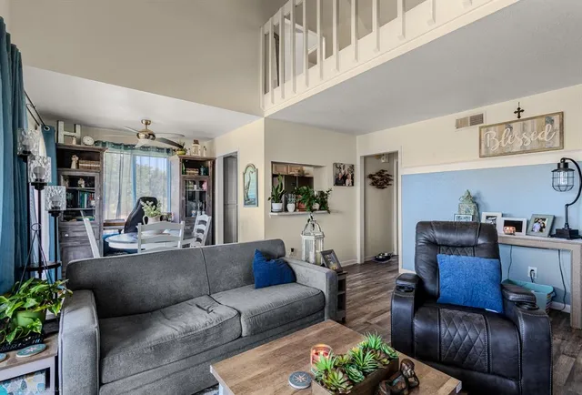 a living room with furniture and wooden floor