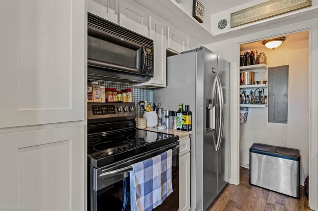 a kitchen with stainless steel appliances a refrigerator stove and microwave