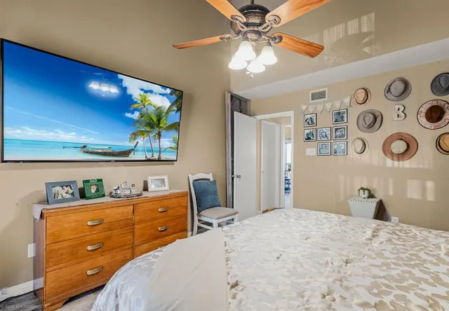 a bedroom with a bed and a dresser in it