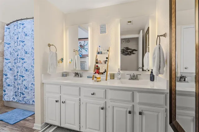 a bathroom with a double vanity sink mirror and double