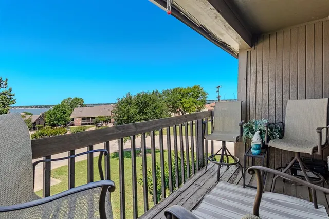 a view of a balcony with chairs