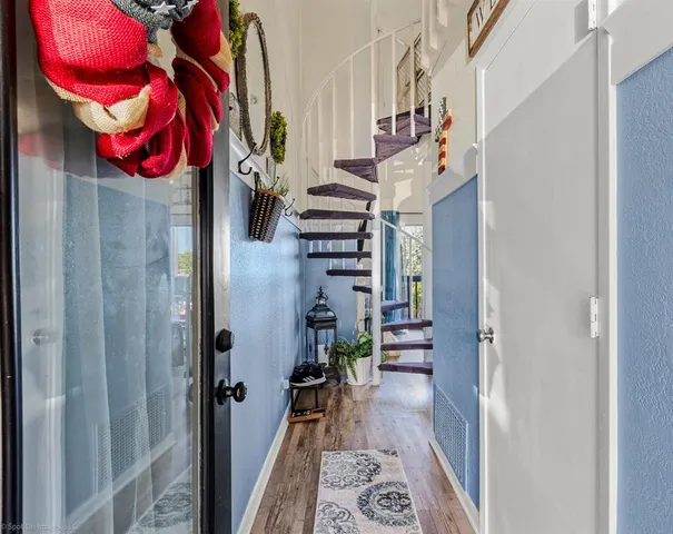 a view of a hallway with couches and dinning table