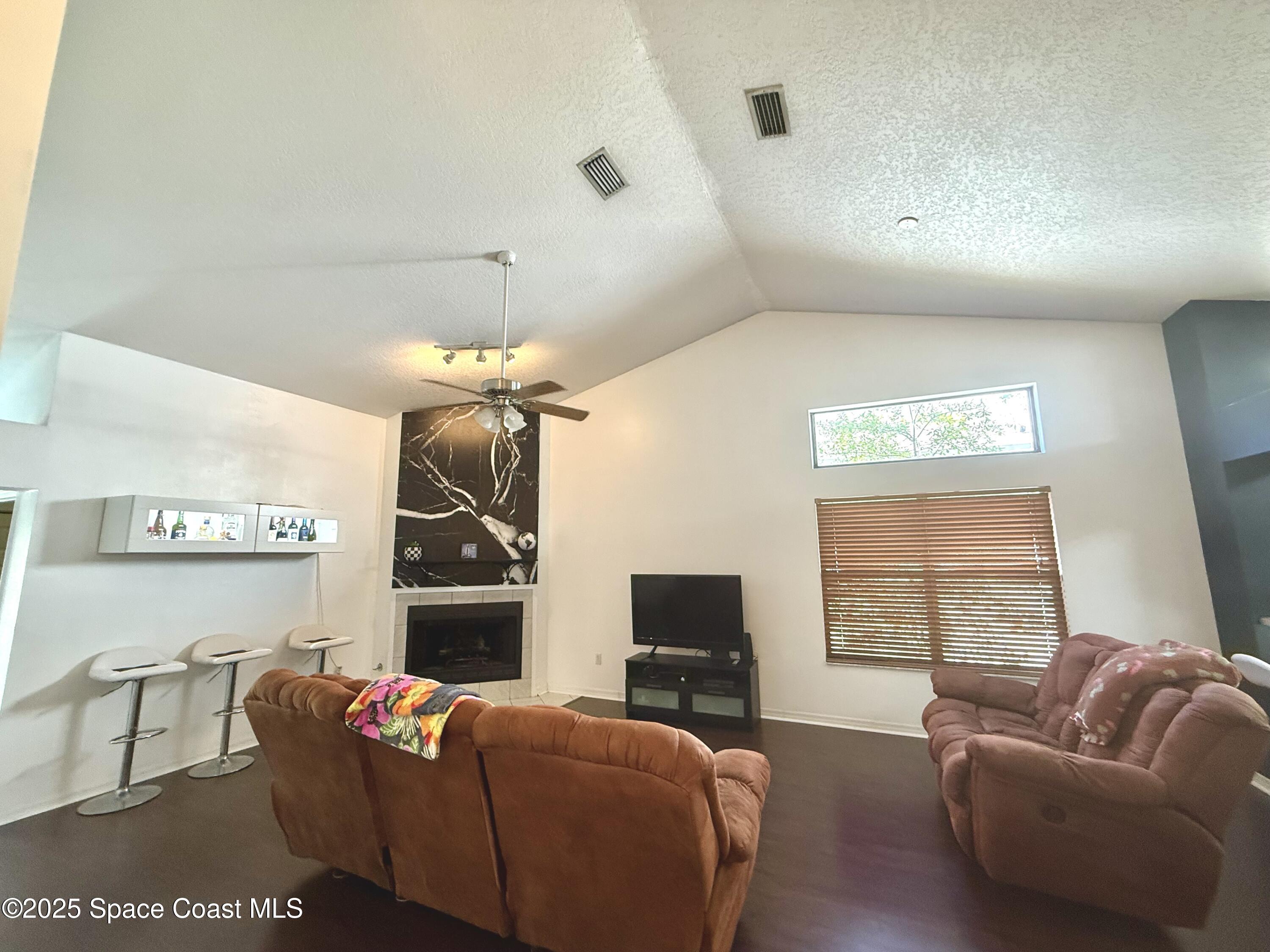 3960 Raney Road Titusville, FL 32780 - Photo 11 of 33 a living room with furniture a window and a flat screen tv