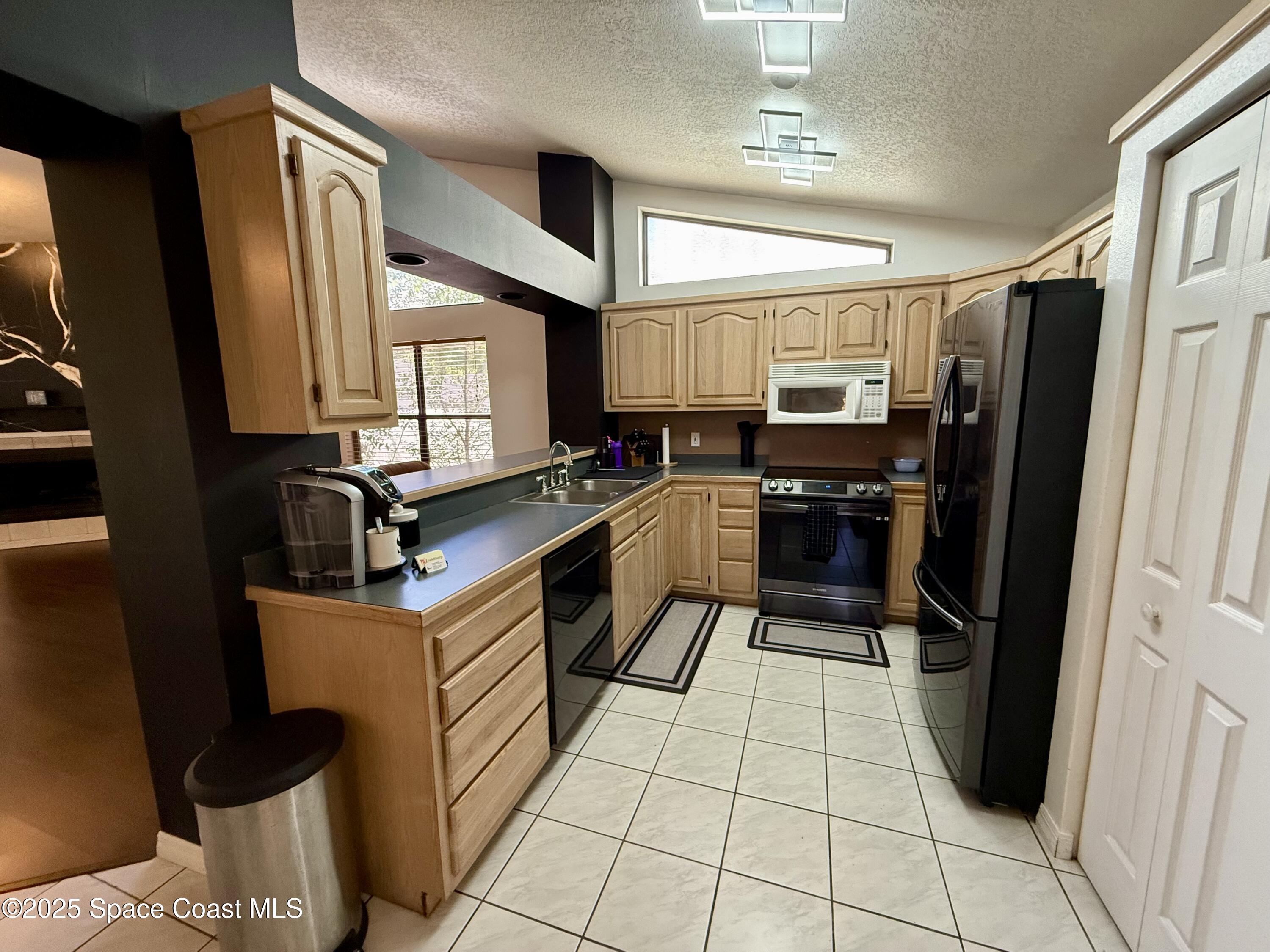 3960 Raney Road Titusville, FL 32780 - Photo 13 of 33 a kitchen with a sink appliances and cabinets