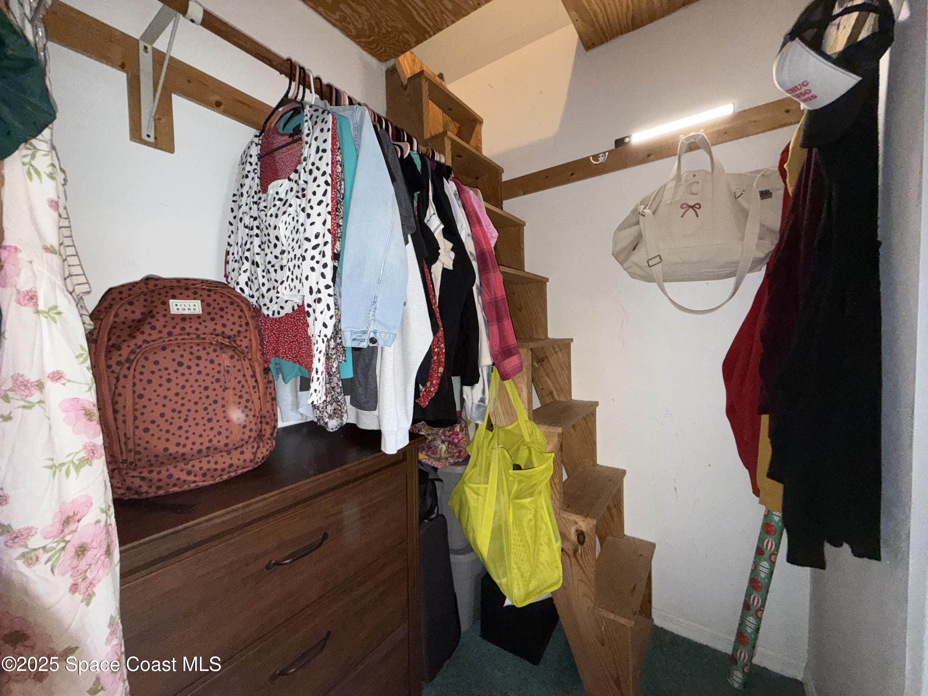 3960 Raney Road Titusville, FL 32780 - Photo 20 of 33 a view of walk in closet with clothes and shoes