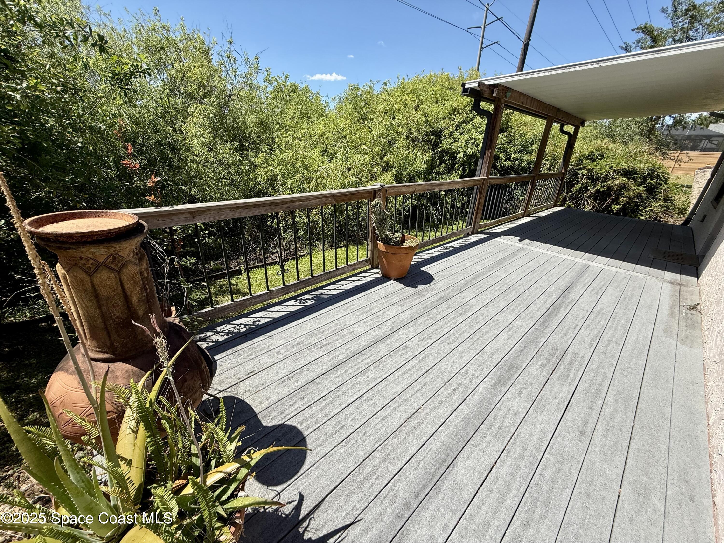 3960 Raney Road Titusville, FL 32780 - Photo 27 of 33 a view of balcony with wooden floor and outdoor seating