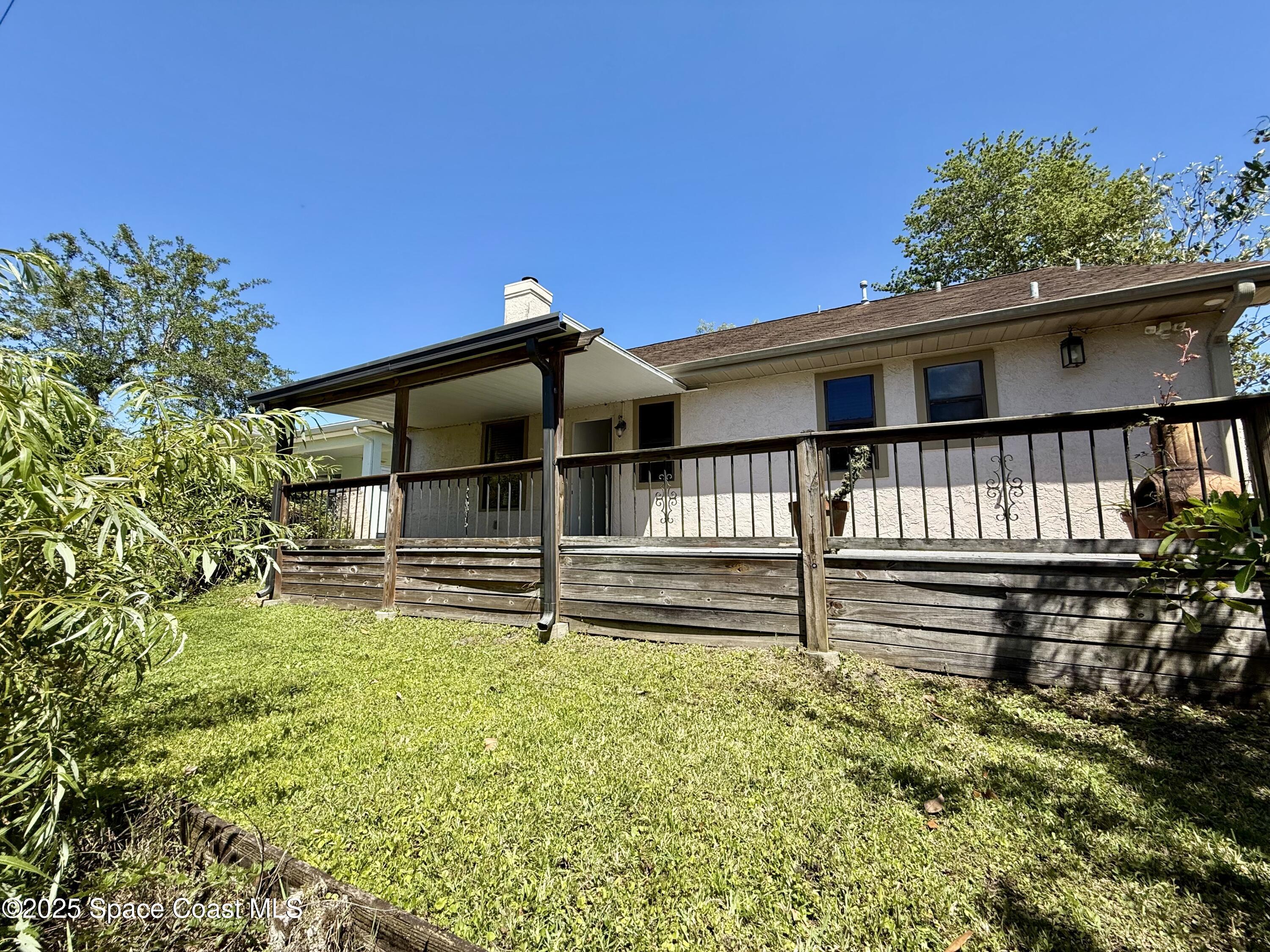 3960 Raney Road Titusville, FL 32780 - Photo 29 of 33 a view of house with a big yard and potted plants