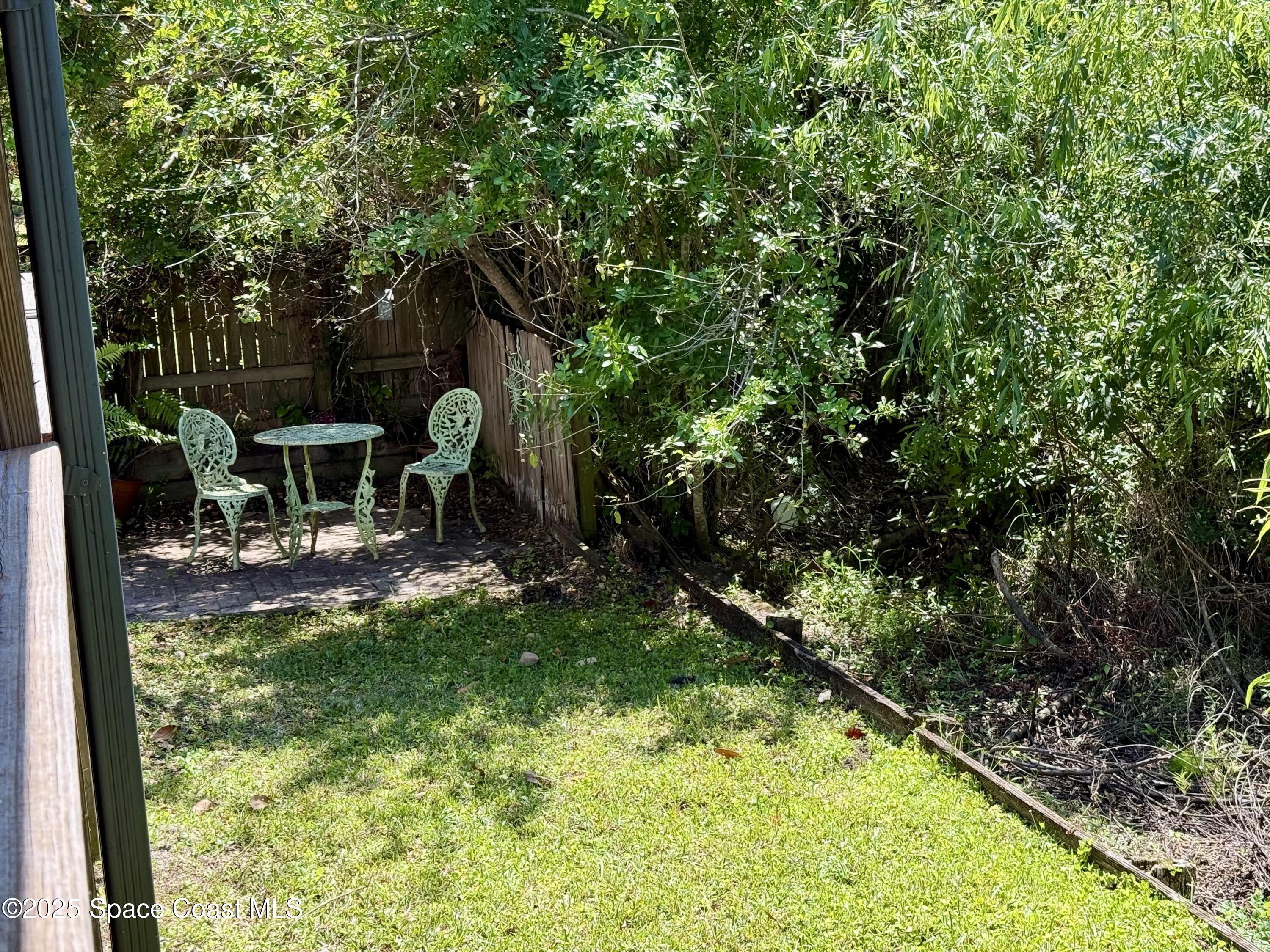 3960 Raney Road Titusville, FL 32780 - Photo 31 of 33 a backyard of a house with yard table and chairs
