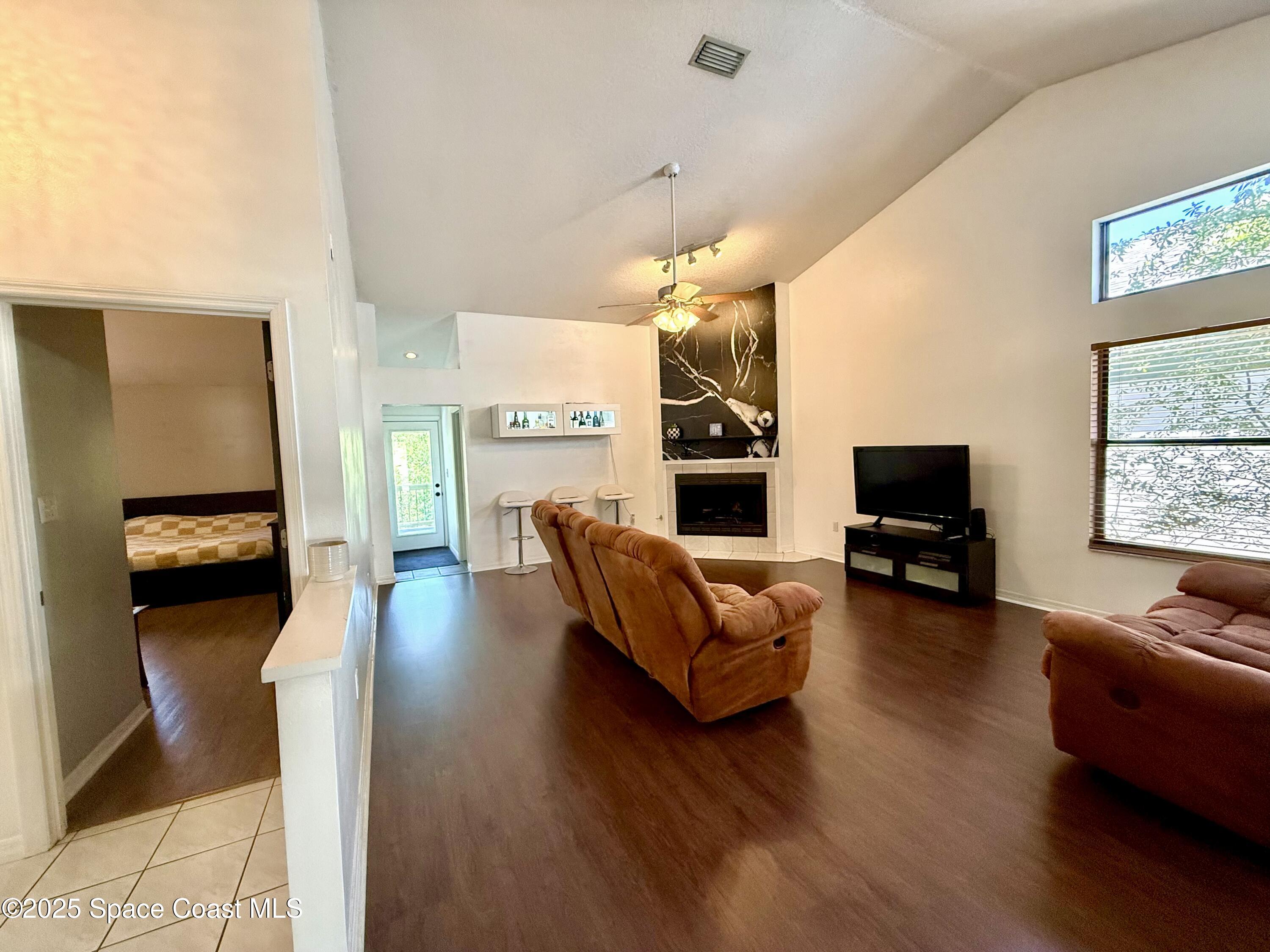 3960 Raney Road Titusville, FL 32780 - Photo 10 of 33 a living room with furniture and a flat screen tv