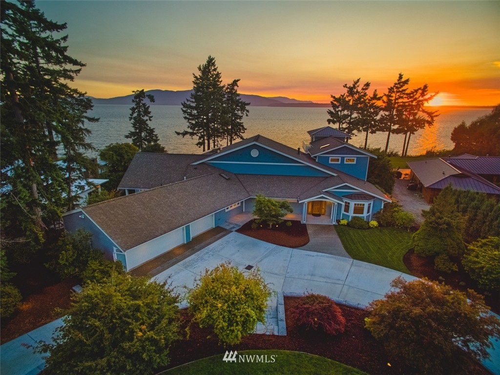 a view of a house with a yard and a tree