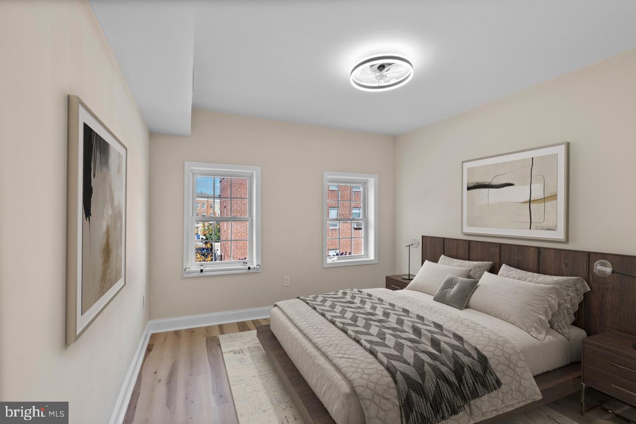 919 Stiles Street Baltimore, MD 21202 - Photo 13 of 35 Serene bedroom with natural light and style.