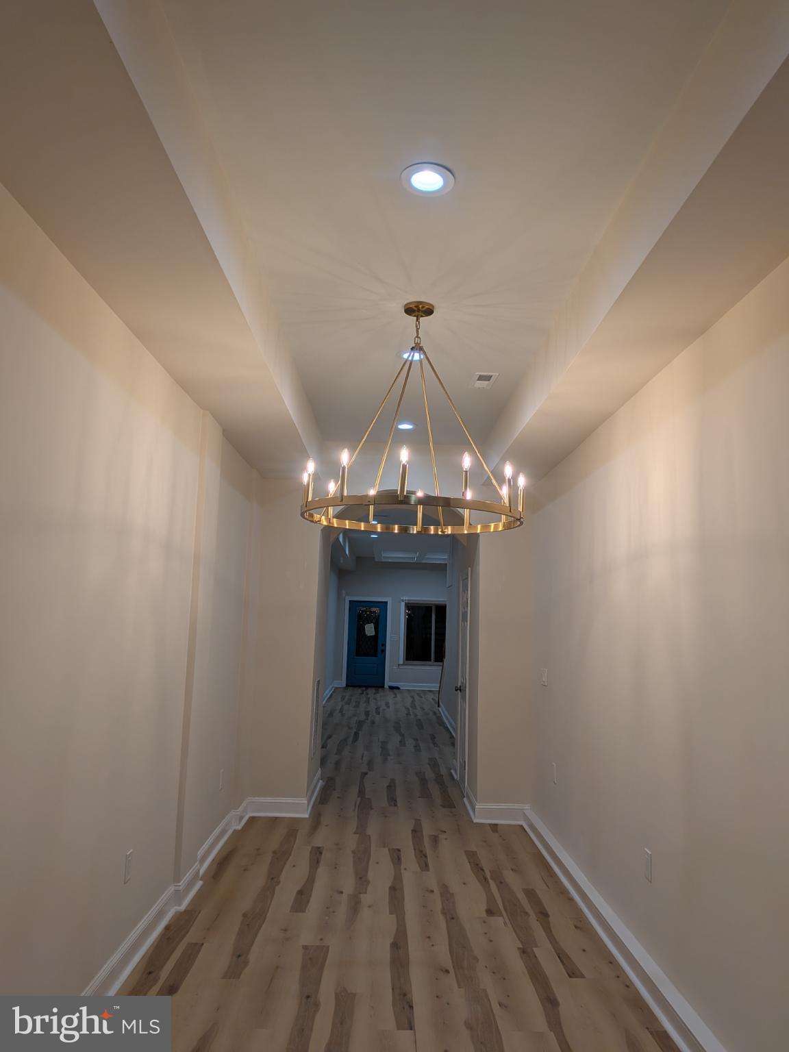 919 Stiles Street Baltimore, MD 21202 - Photo 30 of 35 Elegant hallway with modern chandelier.