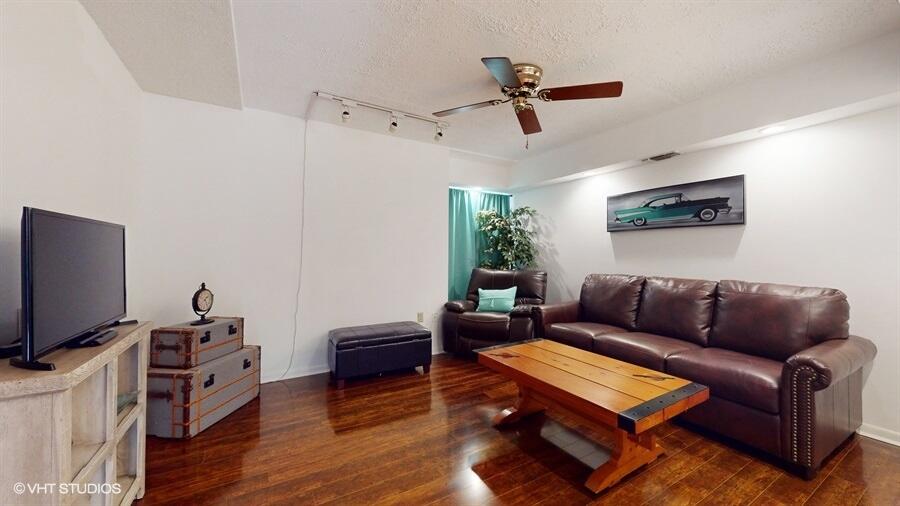 128 Cape Pointe Circle Jupiter, FL 33477 - Photo 15 of 42 a living room with furniture and a flat screen tv