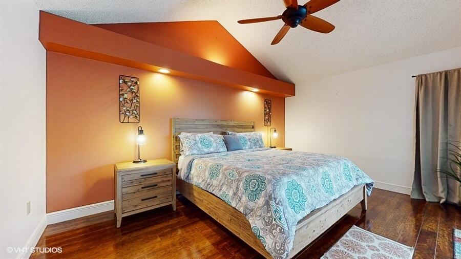 128 Cape Pointe Circle Jupiter, FL 33477 - Photo 17 of 42 a bedroom with a bed and wooden floor