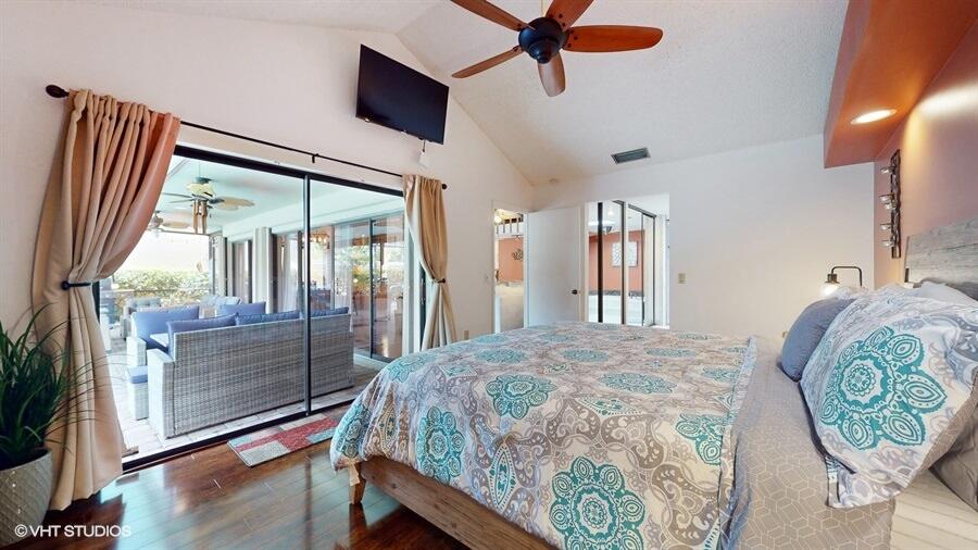 128 Cape Pointe Circle Jupiter, FL 33477 - Photo 18 of 42 a bedroom with a bed and a mirror