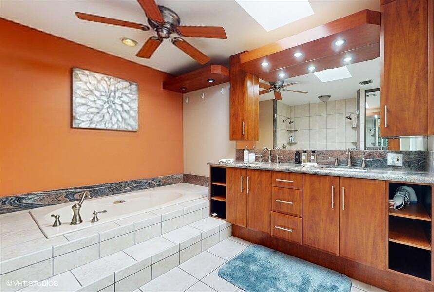 128 Cape Pointe Circle Jupiter, FL 33477 - Photo 20 of 42 a bathroom with a sink a vanity and mirror