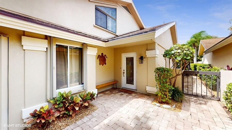 128 Cape Pointe Circle Jupiter, FL 33477 - Photo 2 of 42 a view of a entryway of the house