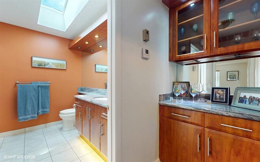 128 Cape Pointe Circle Jupiter, FL 33477 - Photo 24 of 42 a bathroom with a granite countertop sink and a mirror