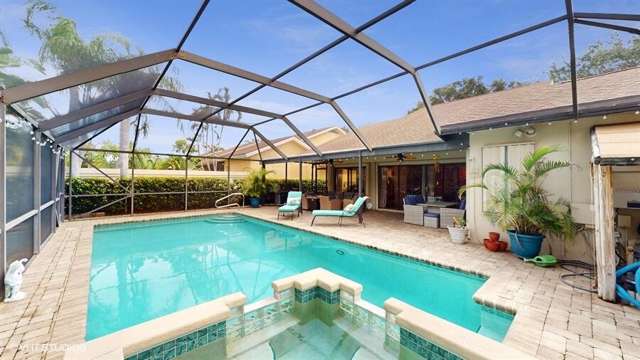 128 Cape Pointe Circle Jupiter, FL 33477 - Photo 37 of 42 a view of a swimming pool with a patio