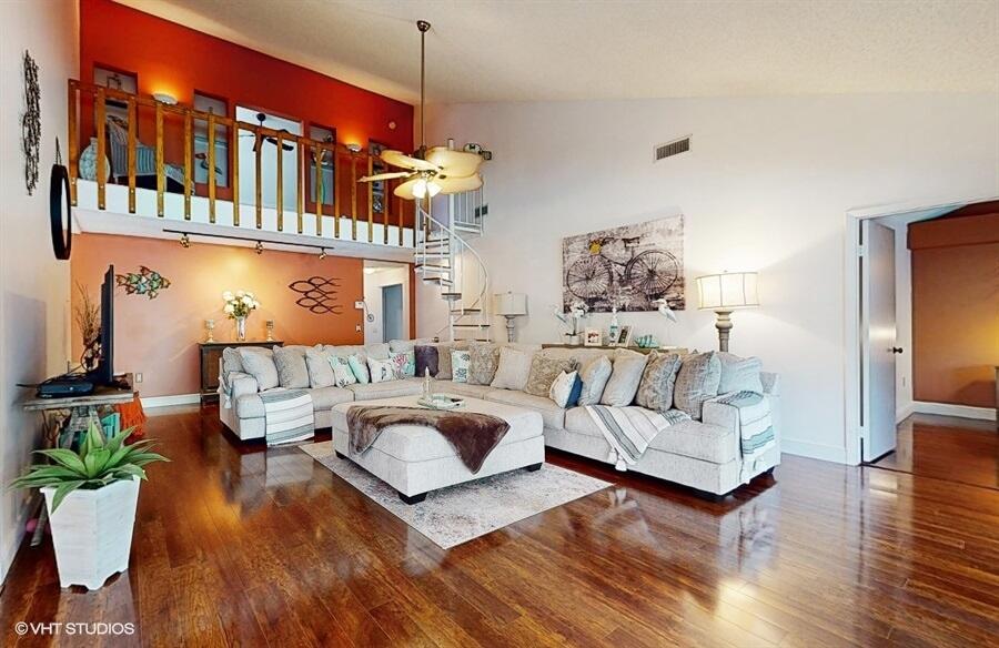128 Cape Pointe Circle Jupiter, FL 33477 - Photo 7 of 42 a living room with furniture fireplace and wooden floor