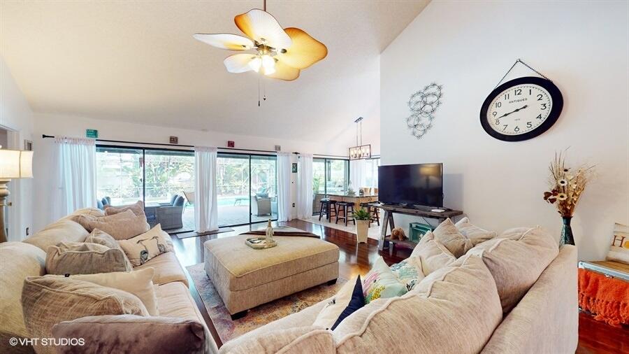 128 Cape Pointe Circle Jupiter, FL 33477 - Photo 8 of 42 a living room with furniture a large window and a flat screen tv