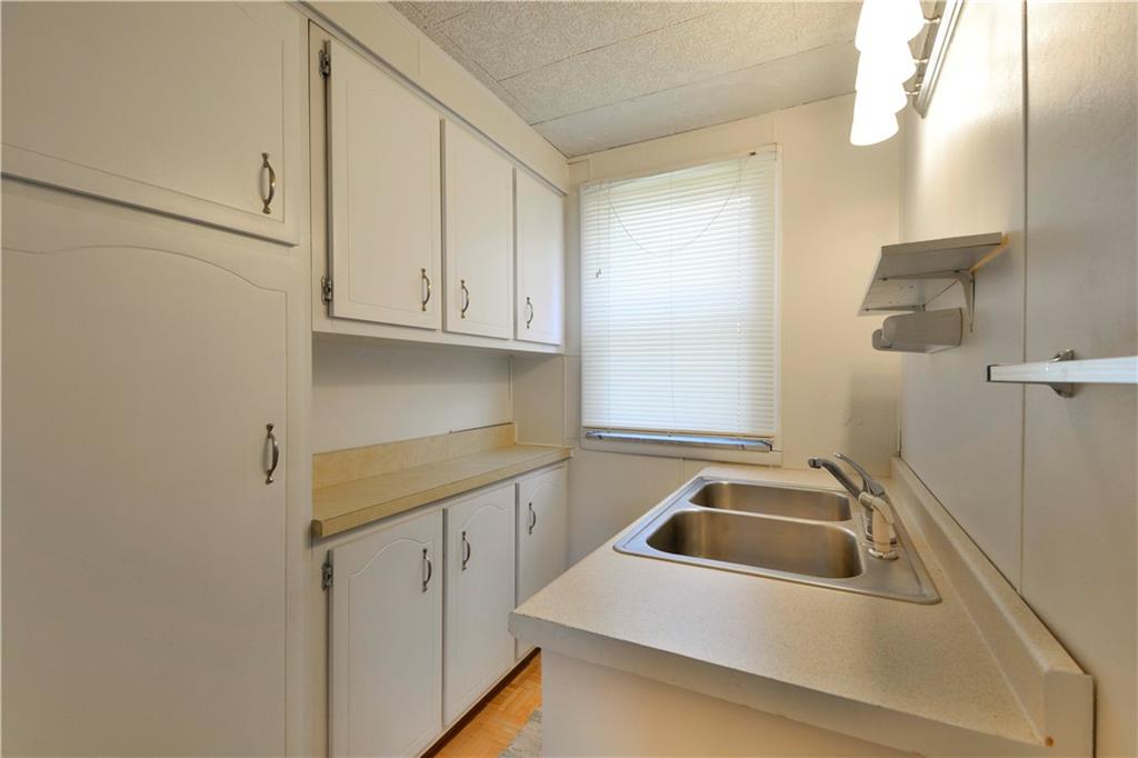 714 Main Street Coraopolis, PA 15108 - Photo 7 of 13 a kitchen with white cabinets and a sink