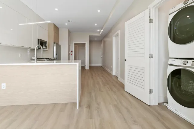 a view of a kitchen with wooden floor and a sink