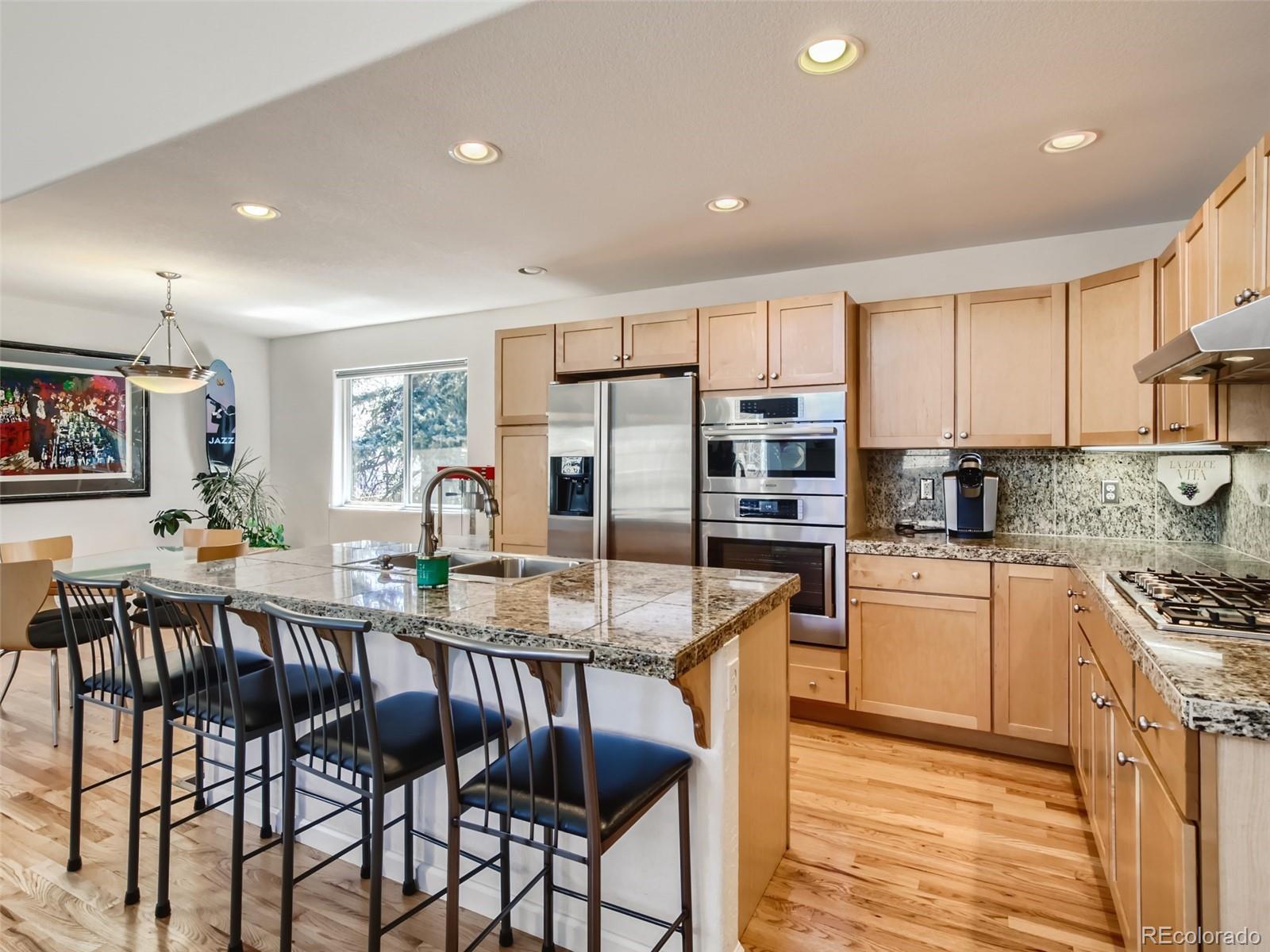 a large kitchen with lots of counter space and stainless steel appliances