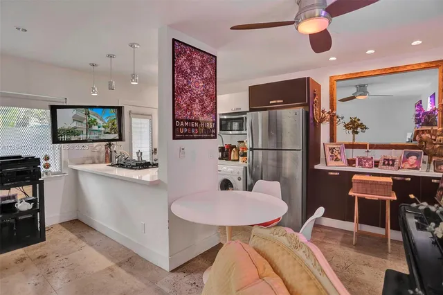 a living room with furniture and kitchen view