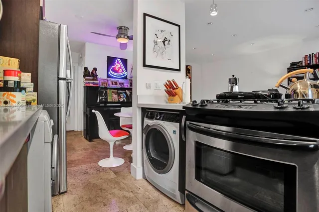 a kitchen with stainless steel appliances granite countertop a refrigerator and a sink