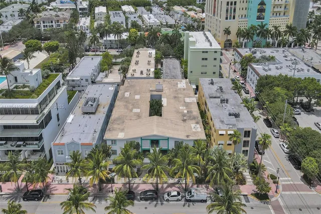 an aerial view of a house with a yard