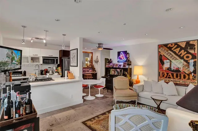 a living room with furniture a rug and a wooden floor