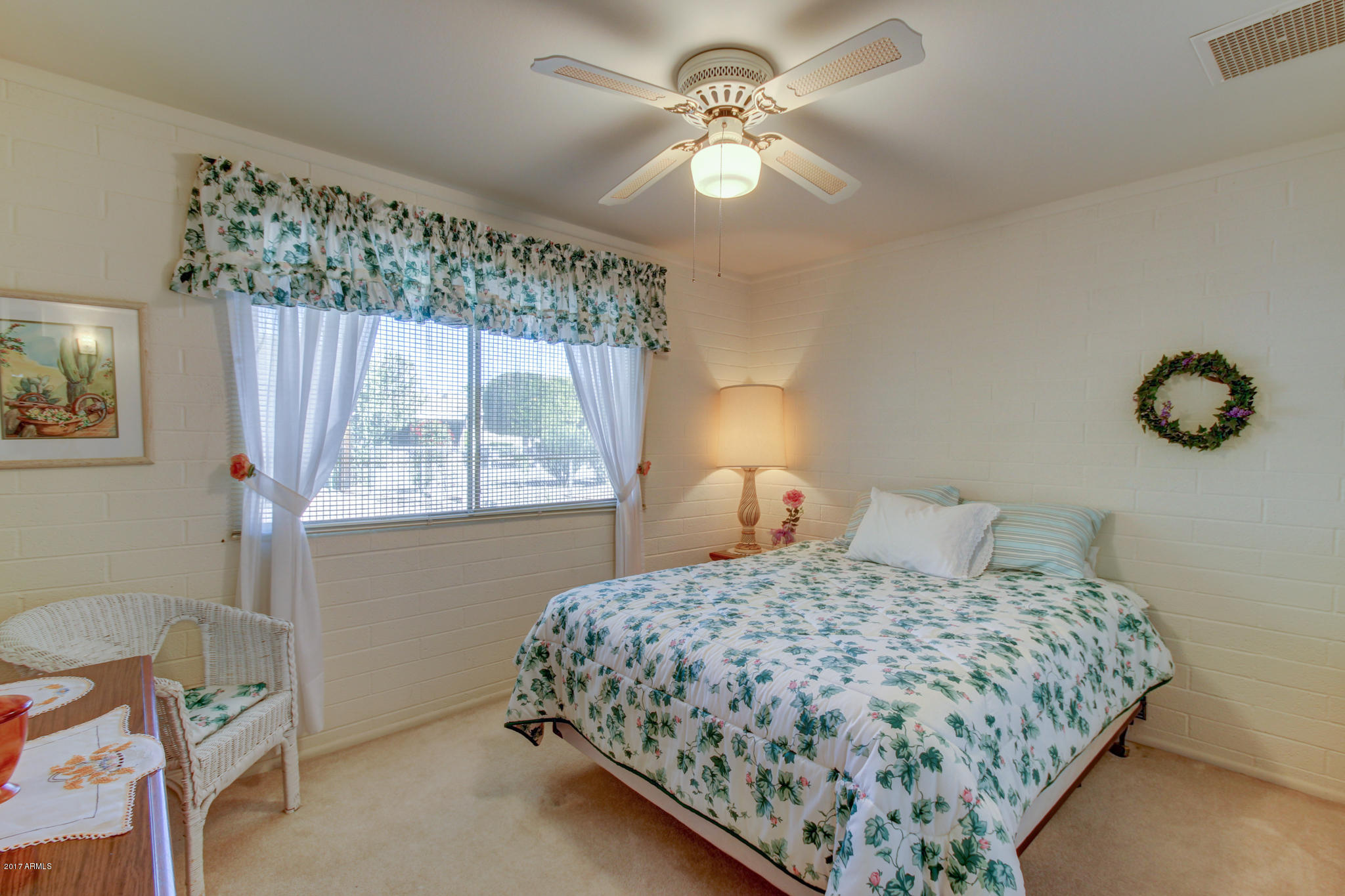 10008 West Riviera Drive Sun City, AZ 85351 - Photo 18 of 26 a bedroom with a bed and a window