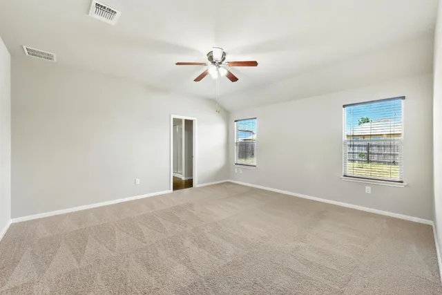 a view of a livingroom with a ceiling fan and window