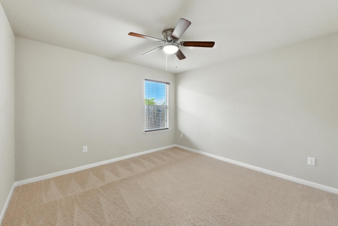 148 Alpha Kyle, TX 78640 - Photo 21 of 36 an empty room with a window and a fan