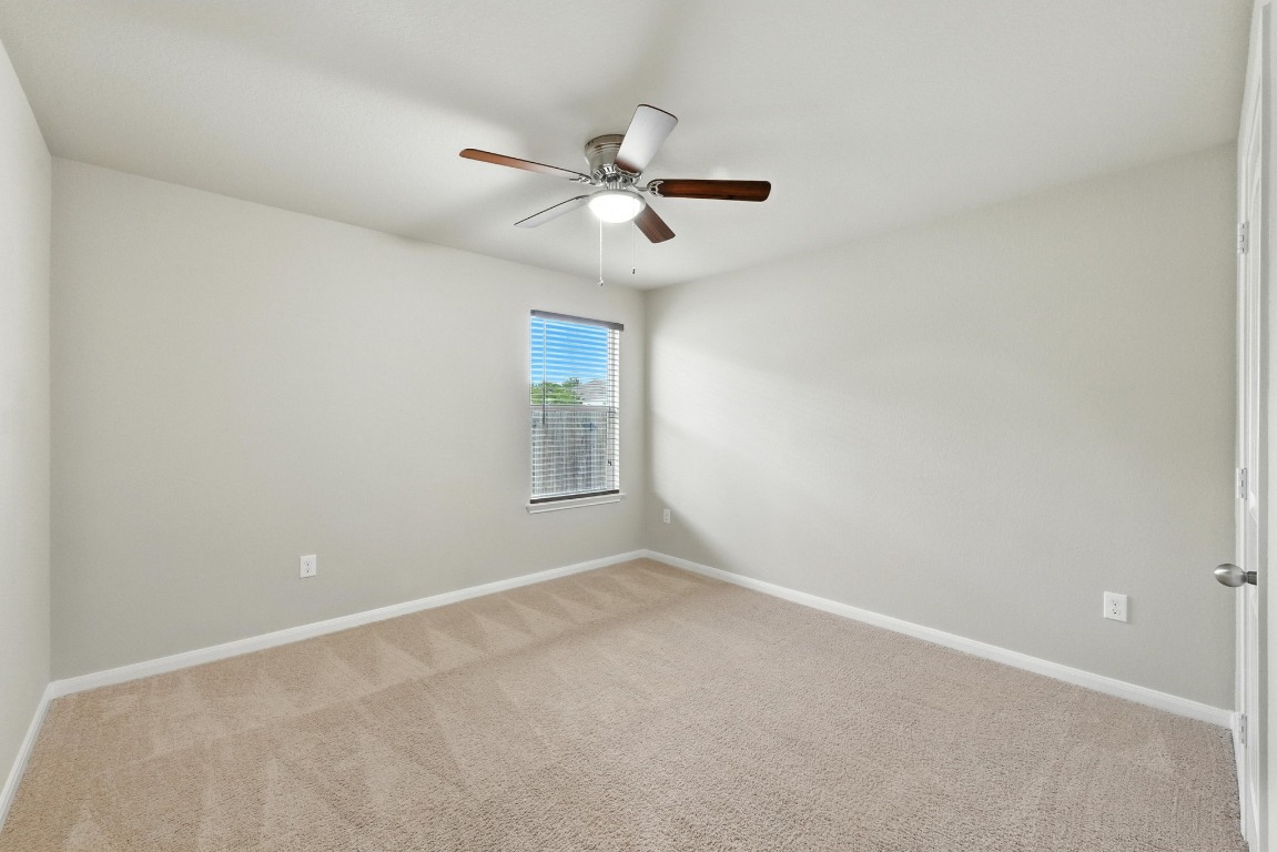 148 Alpha Kyle, TX 78640 - Photo 22 of 36 an empty room with windows and fan