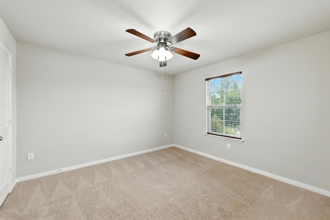 148 Alpha Kyle, TX 78640 - Photo 23 of 36 an empty room with window and a ceiling fan