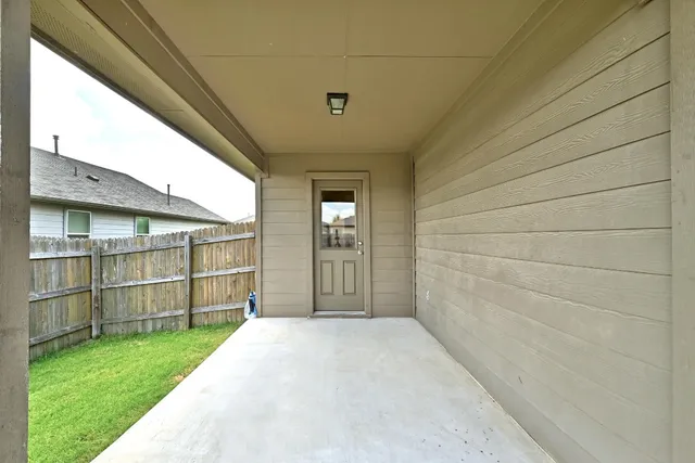 a view of a backyard with wooden fence