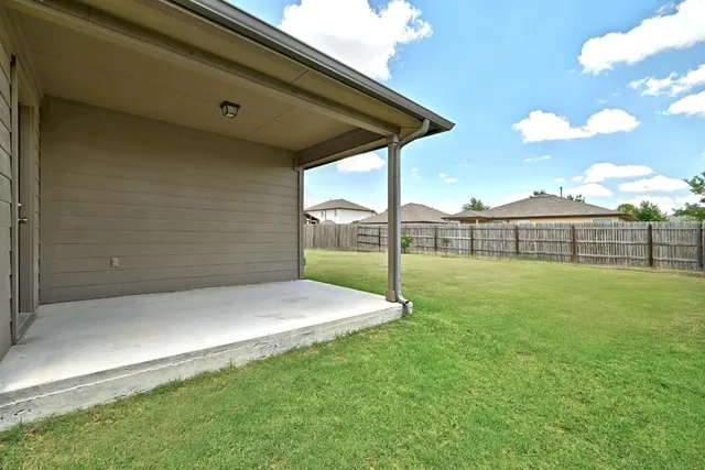 a backyard of a house with lots of green space