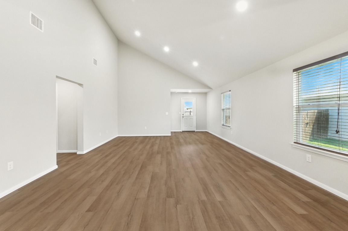 148 Alpha Kyle, TX 78640 - Photo 3 of 36 an empty room with wooden floor and windows