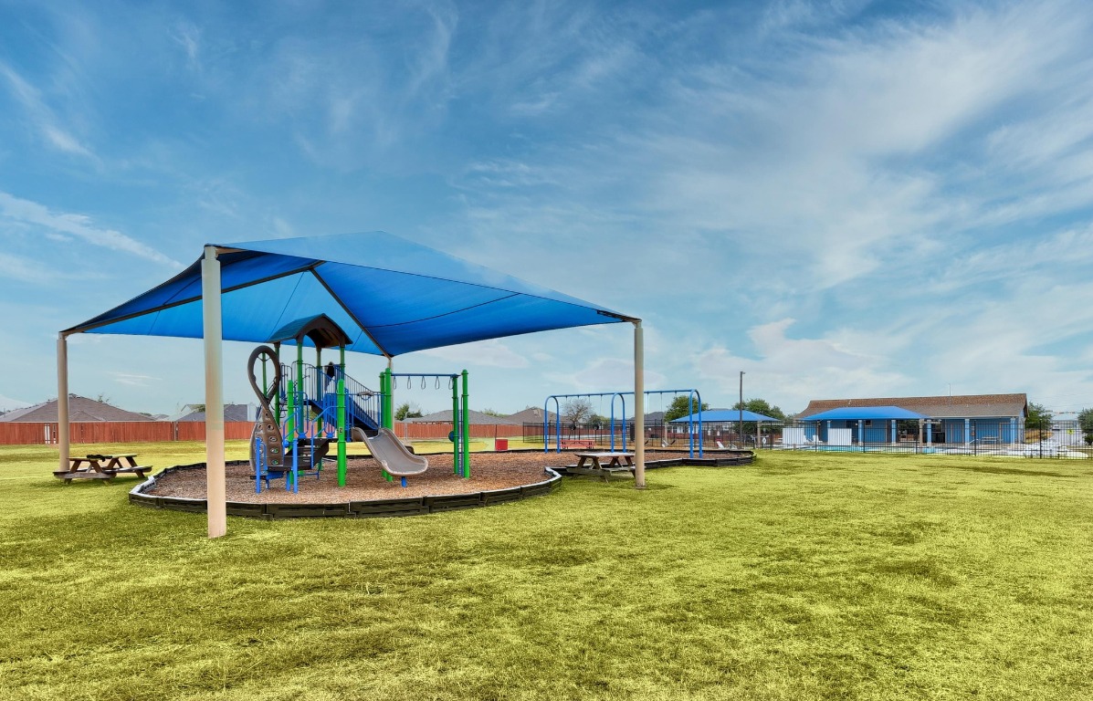 148 Alpha Kyle, TX 78640 - Photo 31 of 36 a view of a swimming pool with lawn chairs under an umbrella