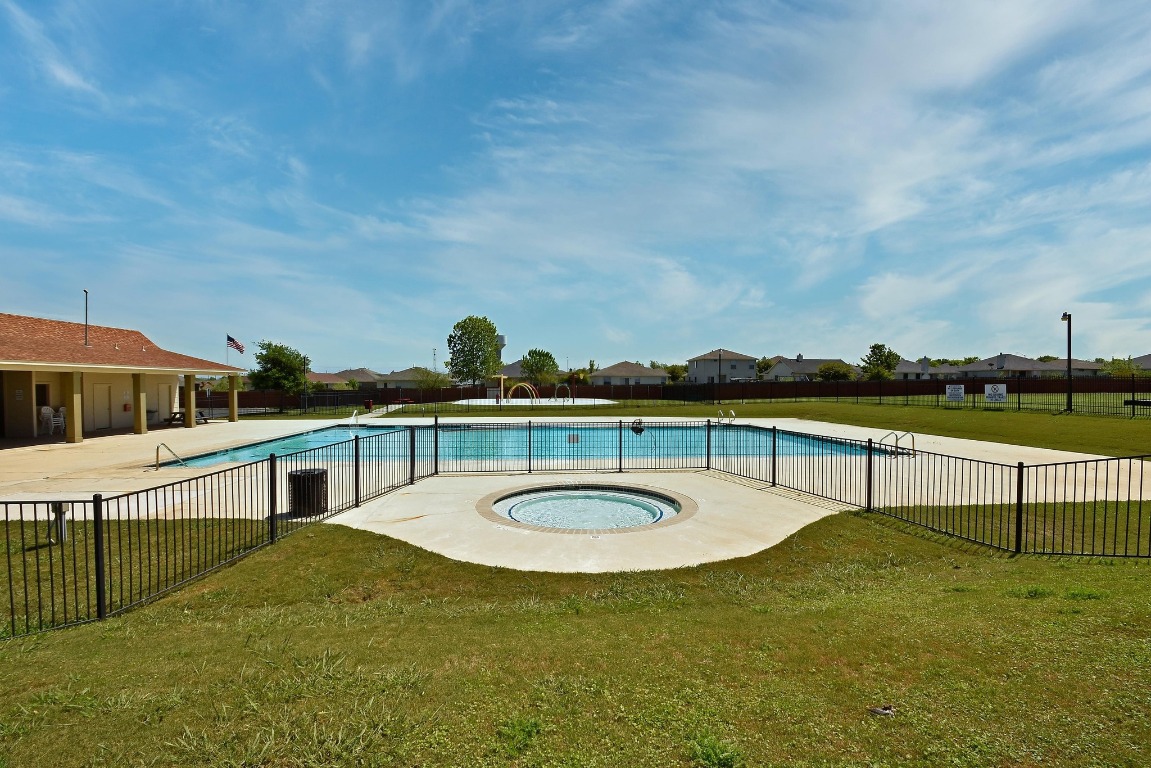 148 Alpha Kyle, TX 78640 - Photo 34 of 36 a view of a swimming pool with a lounge chair