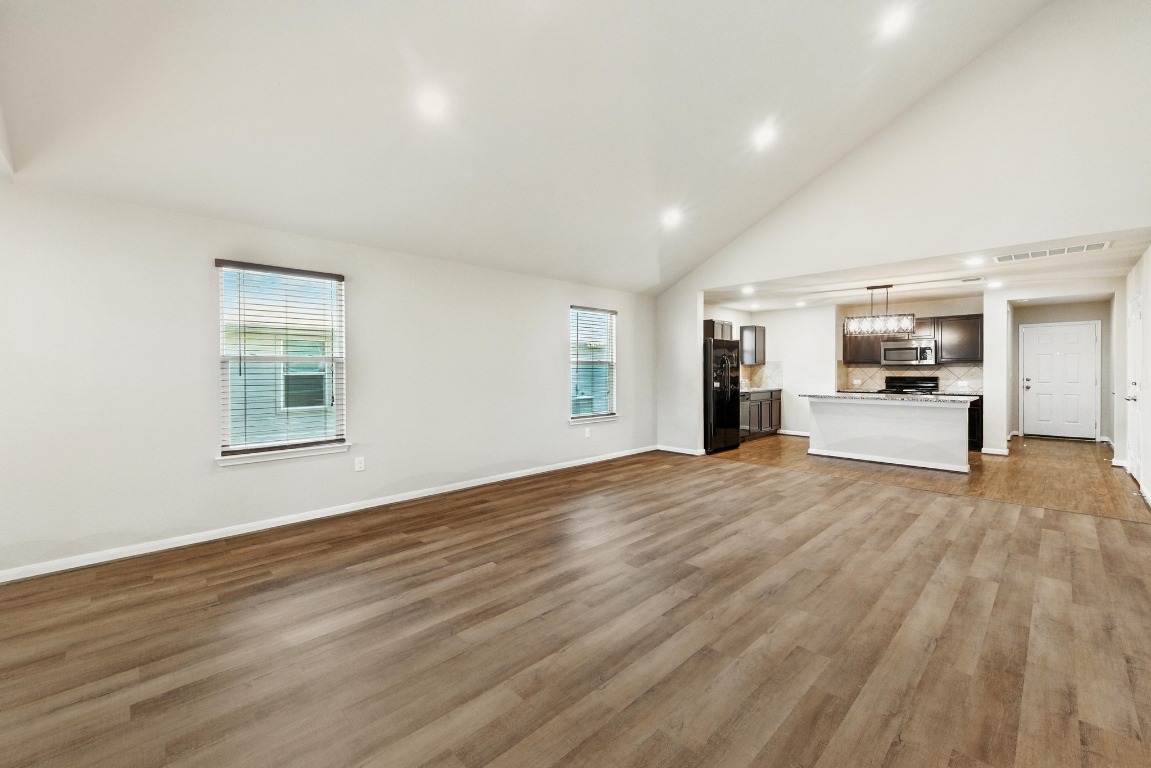 148 Alpha Kyle, TX 78640 - Photo 4 of 36 a view of empty room with wooden floor and window