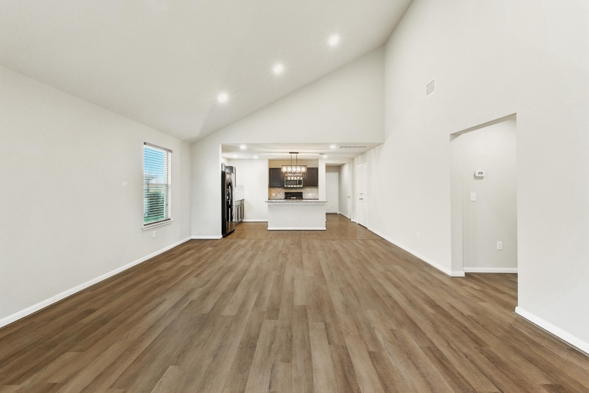148 Alpha Kyle, TX 78640 - Photo 5 of 36 wooden floor in an empty room with a window