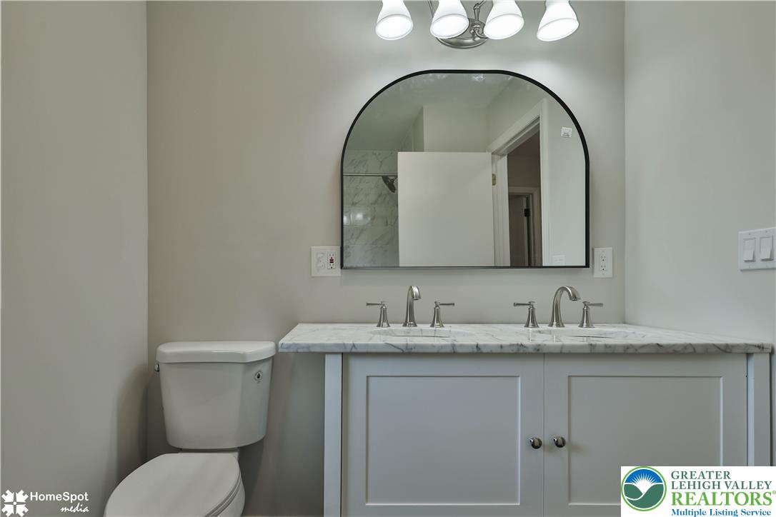 919 Point Phillips Road Bath, PA 18014 - Photo 36 of 59 Double vanity with sleek fixtures and a spacious marble countertop.