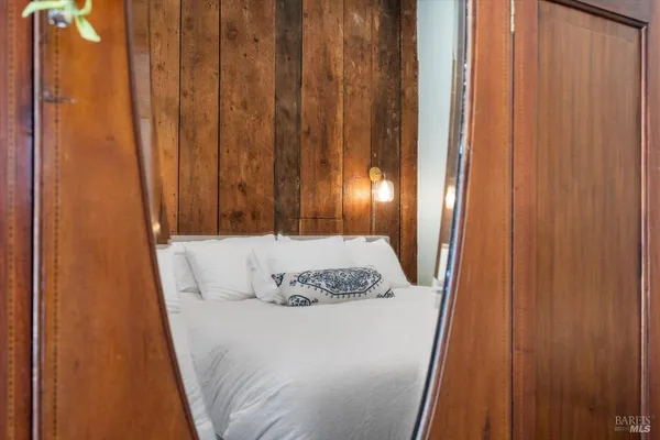 a bedroom with a bed and a wall painting