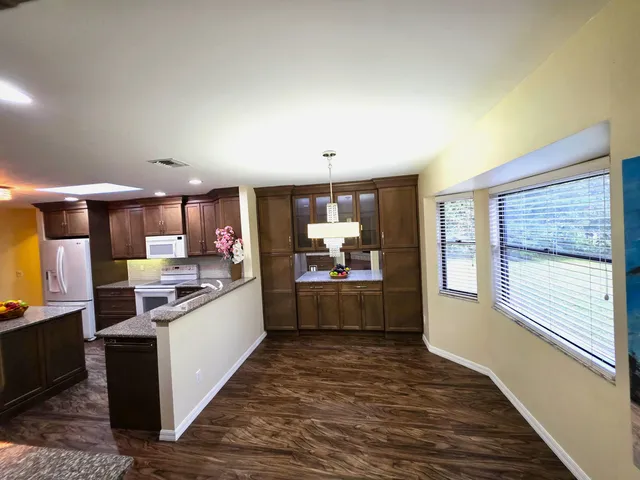 a kitchen with refrigerator and cabinets