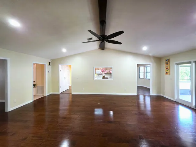 a view of a room with wooden floor