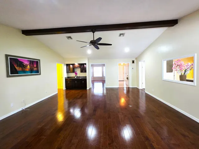 a kitchen with a sink and wooden floor