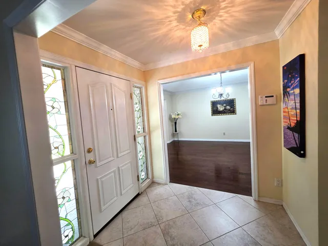 a view of a hallway with bathroom and front door